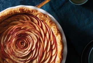 An apple pie with the apple slices arranged in a rose-like pattern